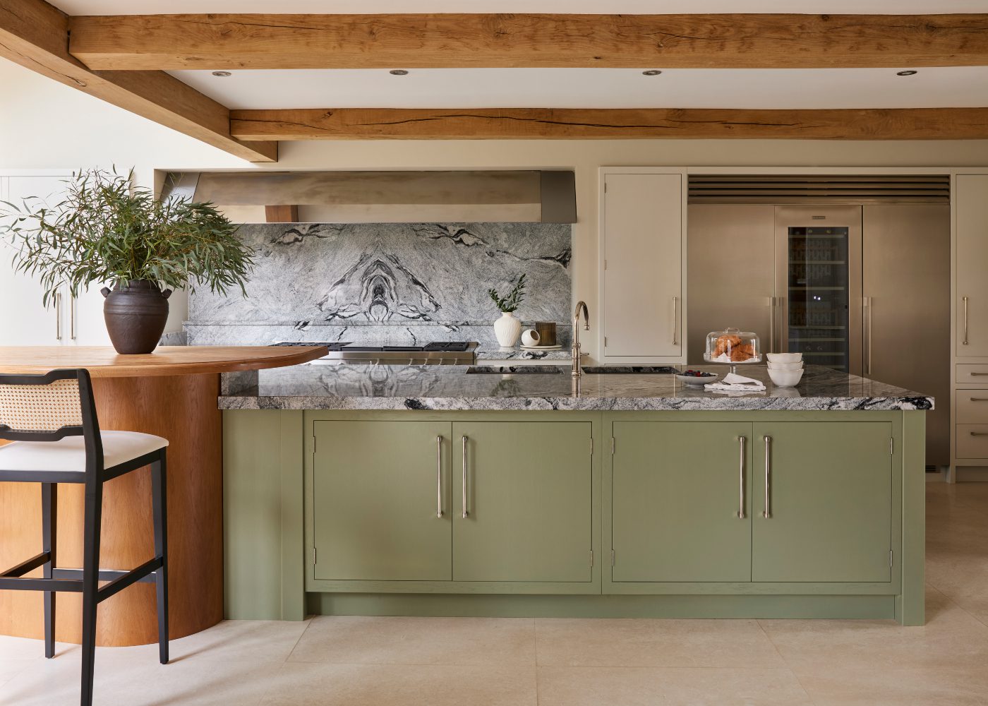 katie watkinson project with eva bar chair Bright kitchen in a modern heritage home with a vibrant green island and a cosy bar, perfect for cooking and socialising.