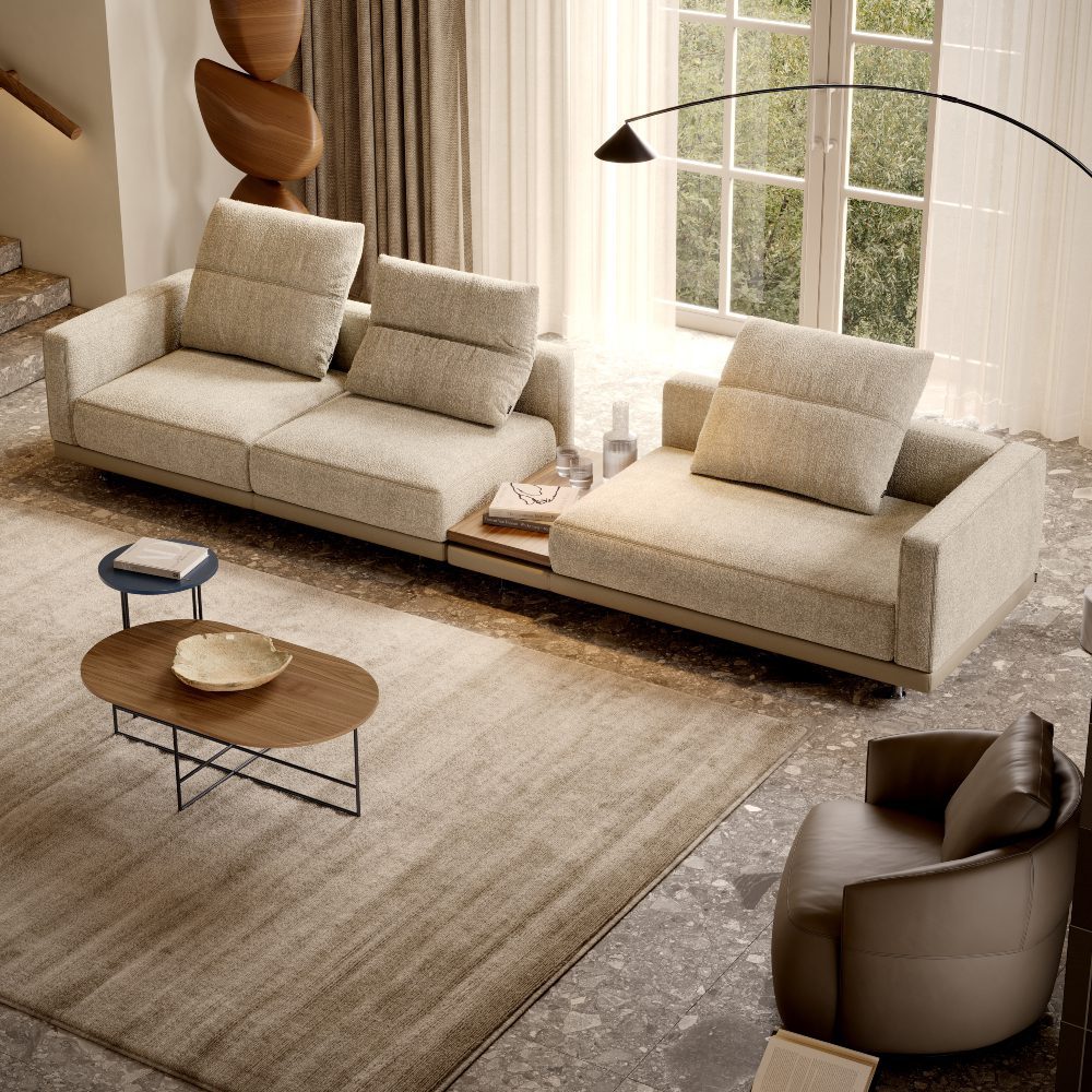 laurent modular sofa in a living room with natural light A stylish living room with a comfortable sofa, a coffee table, and a lamp, designed for relaxation and socialising.
