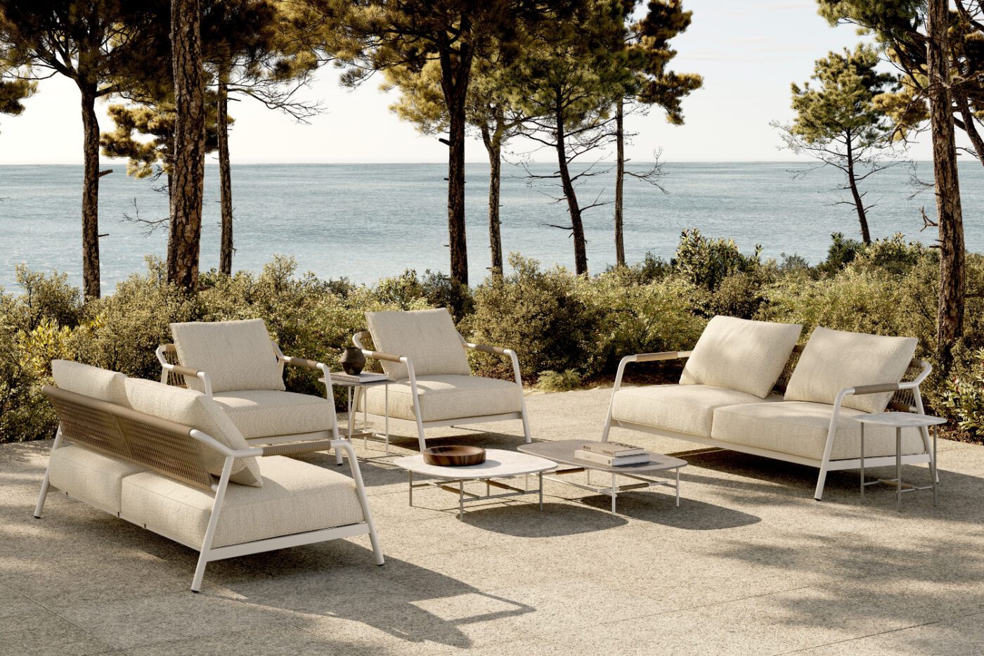 outdoor space with neroli sofas and salema tables Outdoor patio furniture set with a table and white sofas, ideal for dining or lounging in a garden setting. Room by room design.