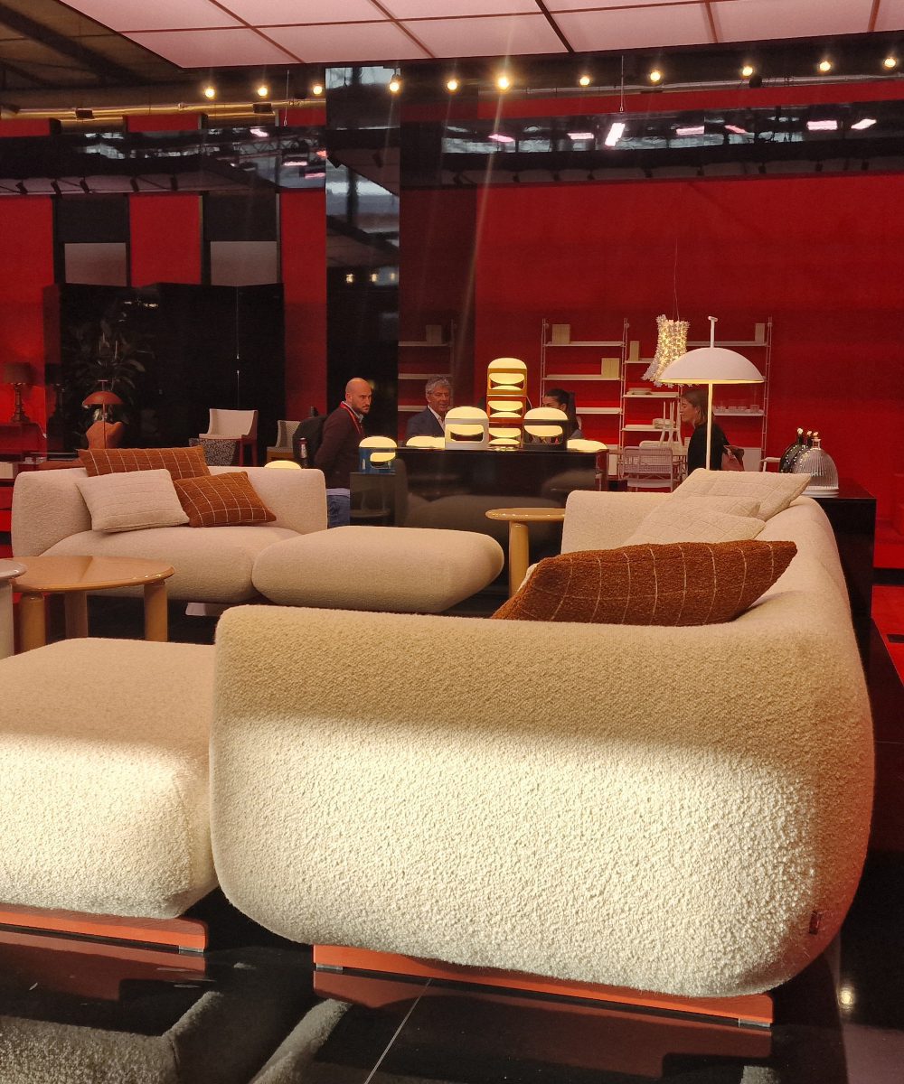 Sofa upholsted in white fabric and with organic shape. Captured at Salone del mobile 2025.